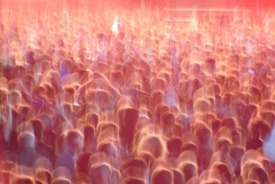 Blurred crowd at a festival with an orangey glow