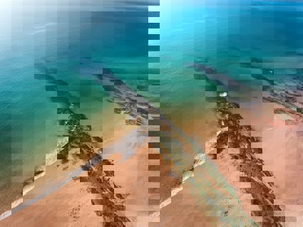 A beach and rocks from above