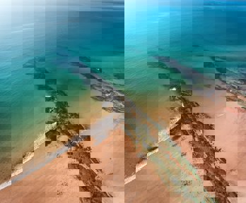 A beach and rocks from above