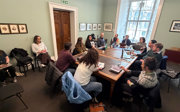 The Latin American Geographies Research Group on their writing retreat, sitting around a table.