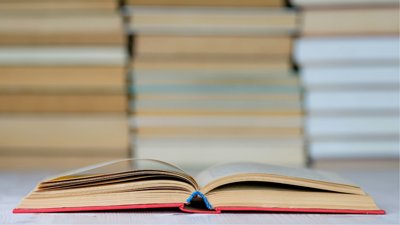 A book layong open on a table.