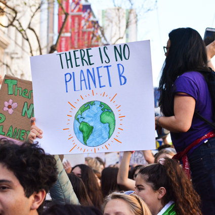 A group of students on a protest, holding a sign saying 'There is no planet B'
