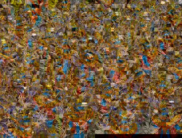 Colourful parade of people wearing elaborate costumes at a Latin American festival.