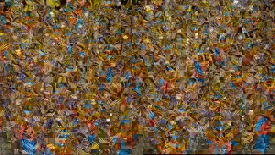 Colourful parade of people wearing elaborate costumes at a Latin American festival.