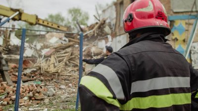 Firefighter looking at collapsed buildings.