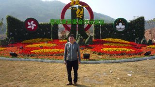 A man standing in front of a flower display,