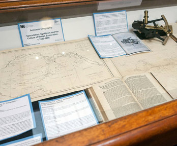 Display of historic materials including maps and books.