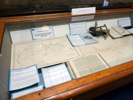 Display of historic materials including maps and books.