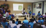 Woman teaching geography to a class.