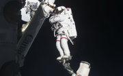 An astronaut in space outside of a space station.