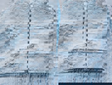 A large iceberg with a crack running down the middle of it