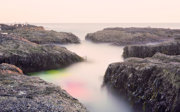 Rocks separated by a sea of mist. 
