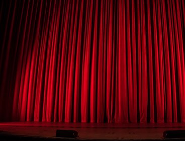 Closed curtains on a theatre stage