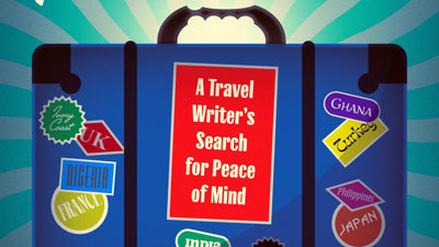 A blue suitcase with stickers all over. 