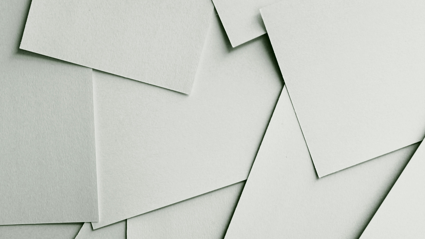 White sheets of paper scattered on top on top of each other