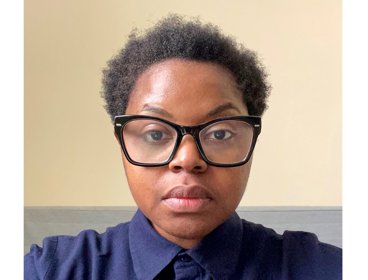 Portrait of a person wearing a dark blue collared shirt