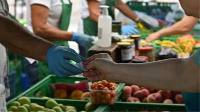 Handing over a ticket at food market.