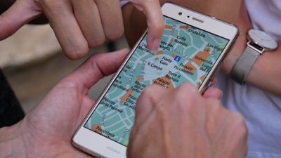 People holding a phone looking at a map