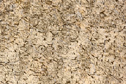 A close up of a cracked surface of dirt