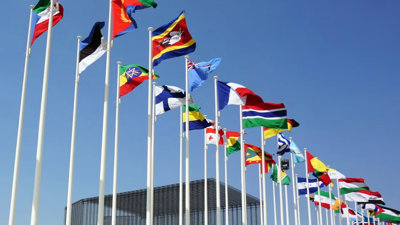Blue sky with international flags flying.