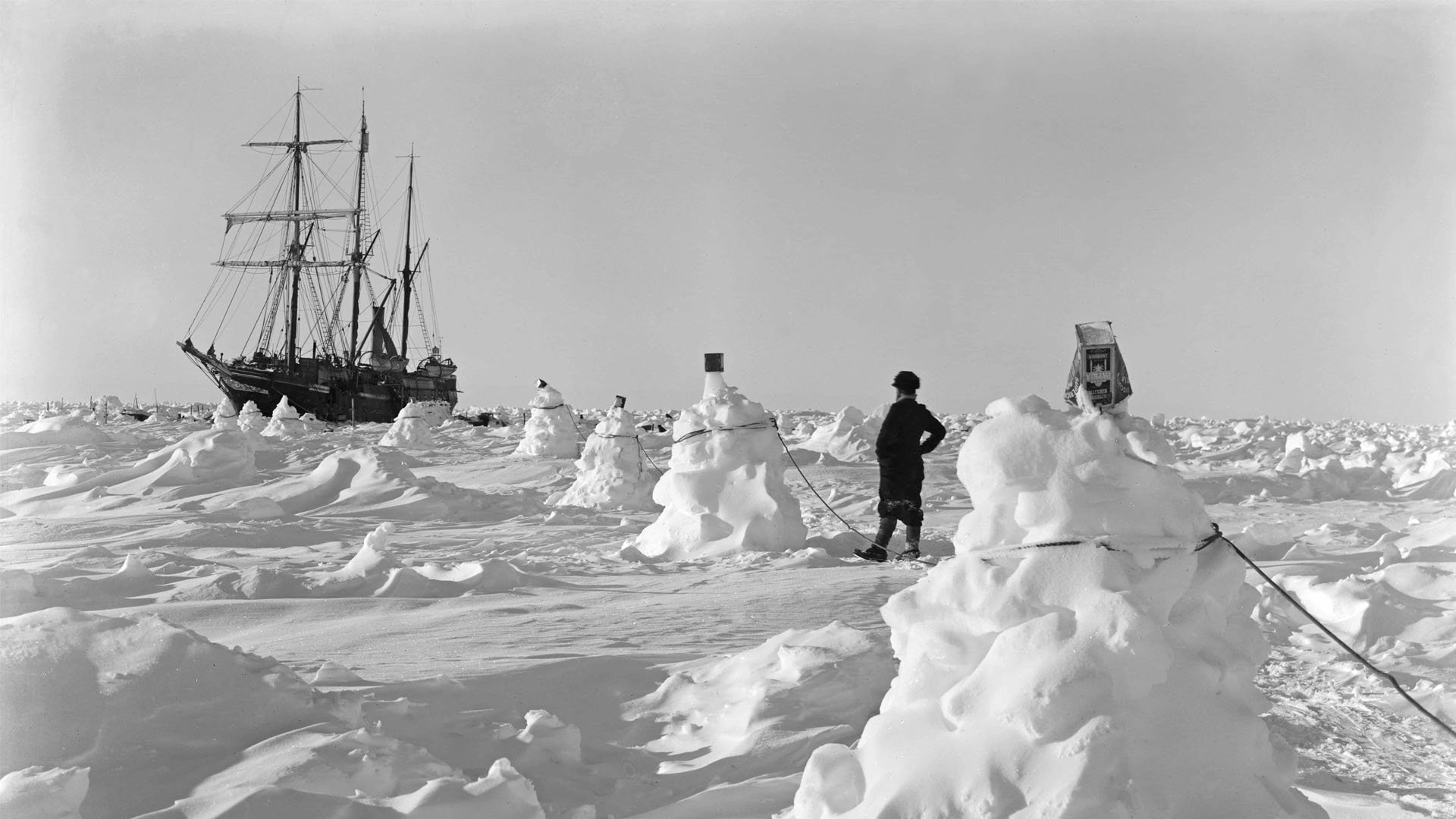 Historical black and white photograph of Endurance frozen in the ice.