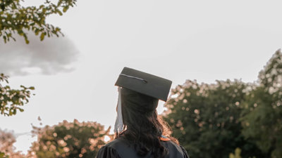 A student wearing a graduation cap seen from behind.