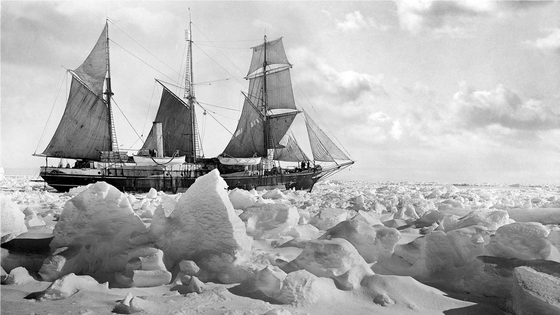 Historical black and white photograph of Endurance ship in the ice.