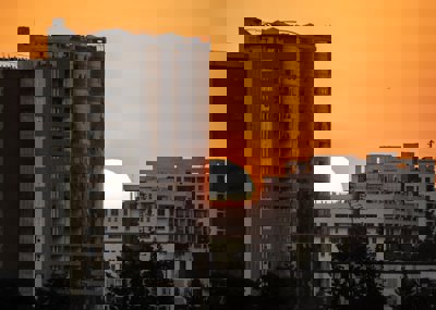 Sun setting behind apartment blocks 
