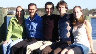 Family of five people posing for a photo.