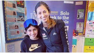Preet Chandi posing with a child dressed as Preet in a school on World Book Day dressed.