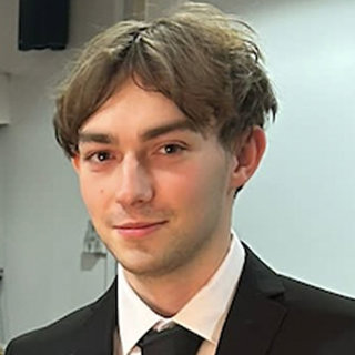 Headshot of Bradley Hart wearing a formal suit and tie.