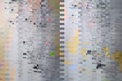 Map of the world with pins stuck in different places.