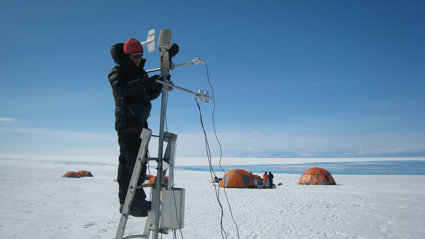 Person operating scientific equipment in polar environment.
