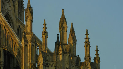 Pinnacles and flying buttresses of an ornate Gothic church.
