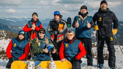 Group with snowboarding kit, on a snow covered mountain. 