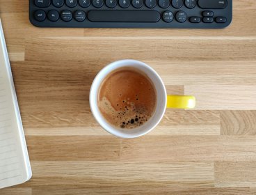 Mug of coffee on desk.