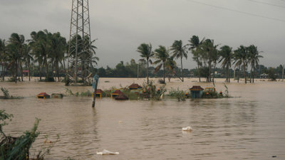 Flood water almost covering buildings.