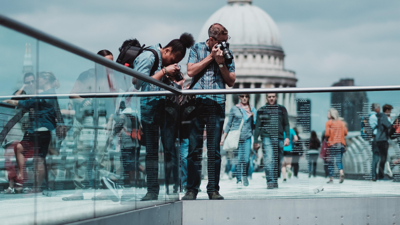 People taking photos on a bridge