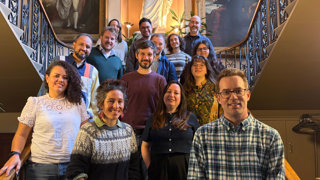 The Latin American Geographies Research Group on their writing retreat, standing on some stairs.