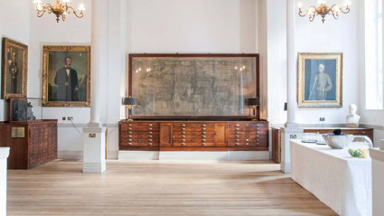 A large map mounted on the wall of the Map Room with a drinks catering station setup to the side.