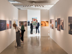 A shot inside the Earth Photo exhibition with guests viewing the photographs.