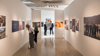 A shot inside the Earth Photo exhibition with guests viewing the photographs.