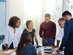 People talking around a table in an office.