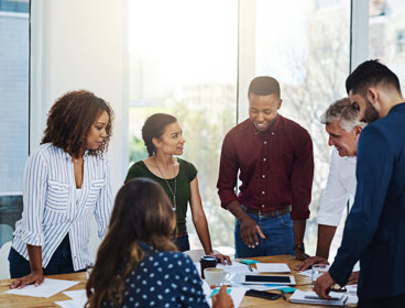 People talking around a table in an office.