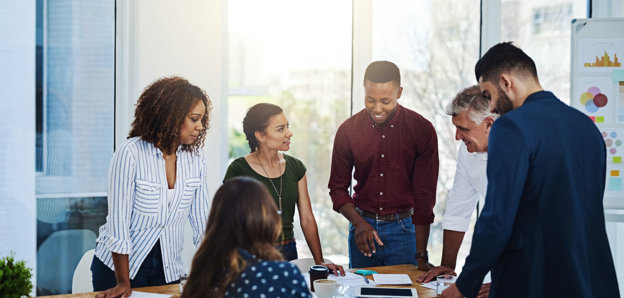 People talking around a table in an office.