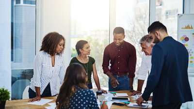 People talking around a table in an office.