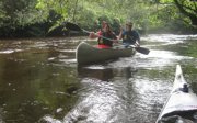 Two people in a canoe on a river.