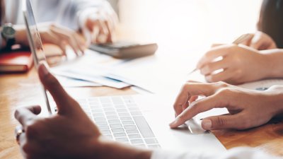 Close up of hands using laptop