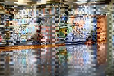 Prem Gil standing in a library