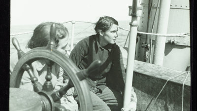 Two members of the British East Greenland Expedition 1935-1936 aboard a boat.